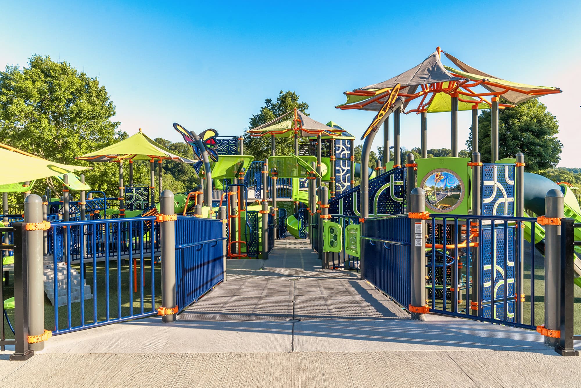 Possibility Playground in Corydon, Indiana, features inclusive play structures under a clear blue sky.