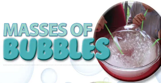Large mass of bubbles in a dish with green straws inserted