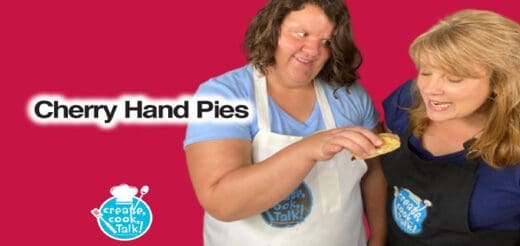 Two women are shown with a cherry hand pie.