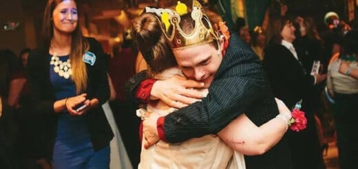 Couple hugging at a formal event.