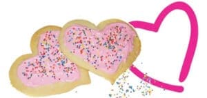 Two heart-shaped cookies with pink frosting and sprinkles next to a pink heart outline.