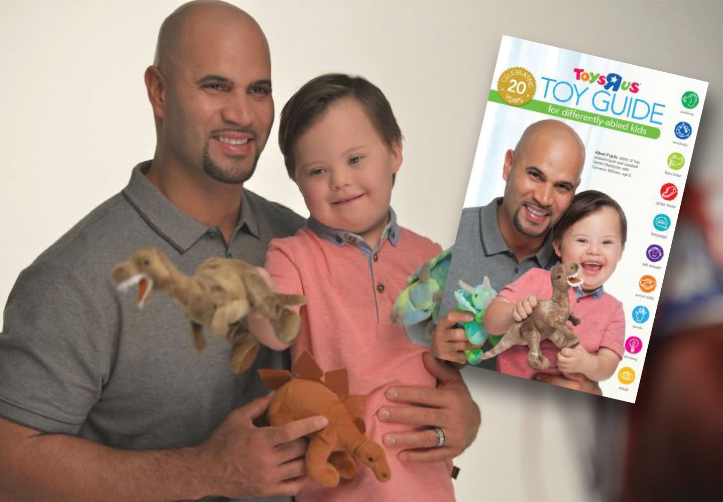 Albert Pujols and a child with Down syndrome hold toys with a Toys "R" Us Toy Guide behind them.