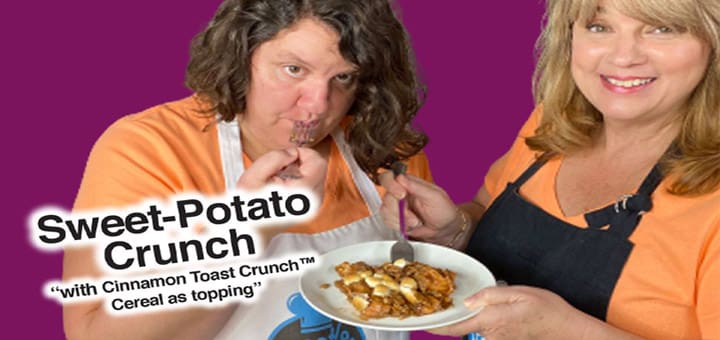 Two people in aprons holding a plate of sweet potato crunch topped with cereal.