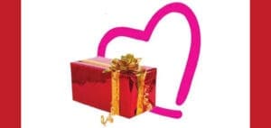 Red gift box with a gold bow in front of a pink heart outline.