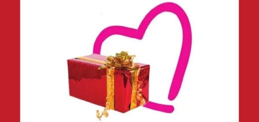 Red gift box with a gold bow in front of a pink heart outline.