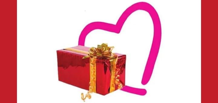 Red gift box with a gold bow in front of a pink heart outline.