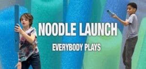 Two children hold pool noodles in front of text reading "NOODLE LAUNCH EVERYBODY PLAYS.