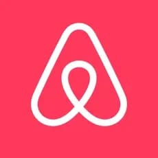Airbnb logo on a red background.