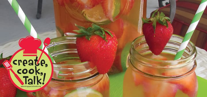 Strawberry and lime infused water in mason jars with fresh strawberries and striped straws.