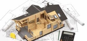 3D model of a house interior sitting on architectural blueprints with a calculator.