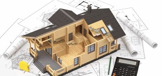 3D model of a house interior sitting on architectural blueprints with a calculator.