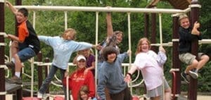 Children climbing on a playground structure.