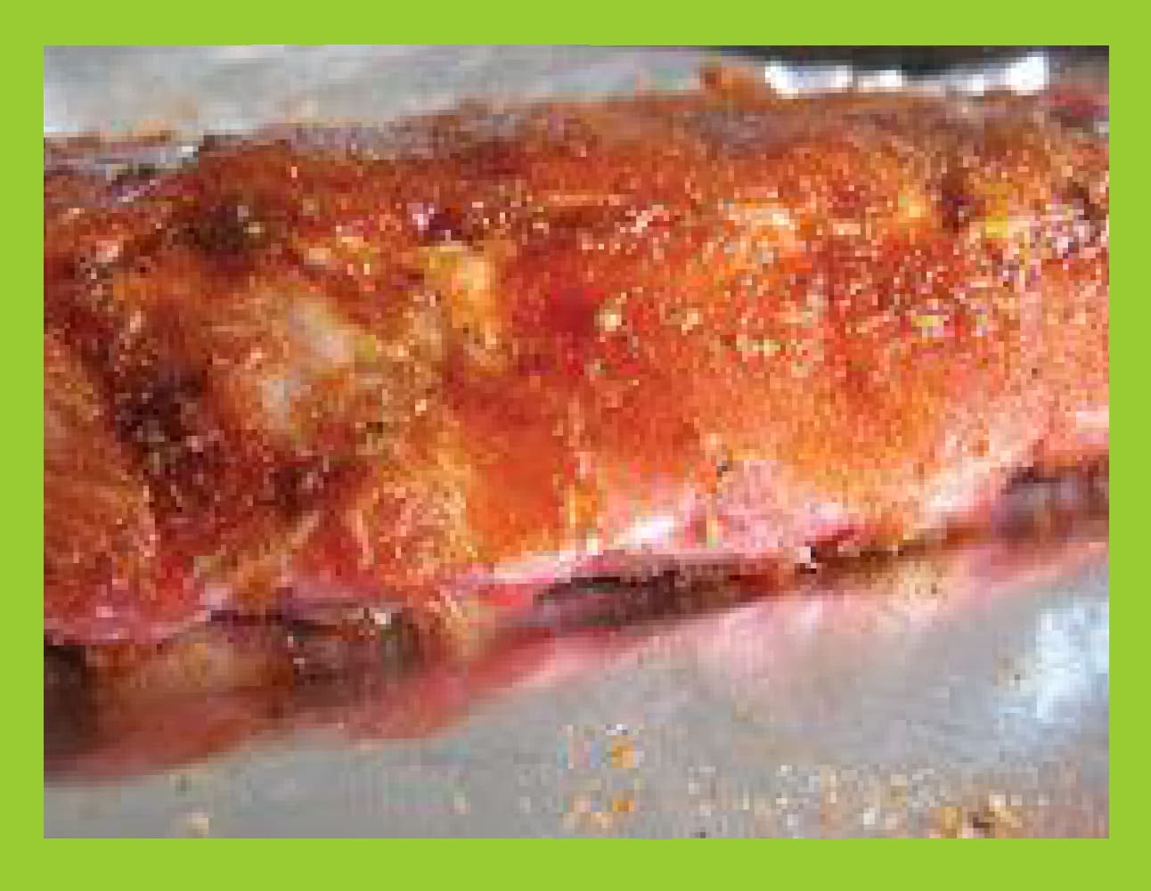 Ribs covered in a dry rub seasoning mixture.