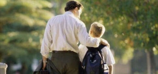 Father with arm around son walking outdoors