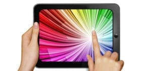 Tablet with colorful screen display and hands touching it