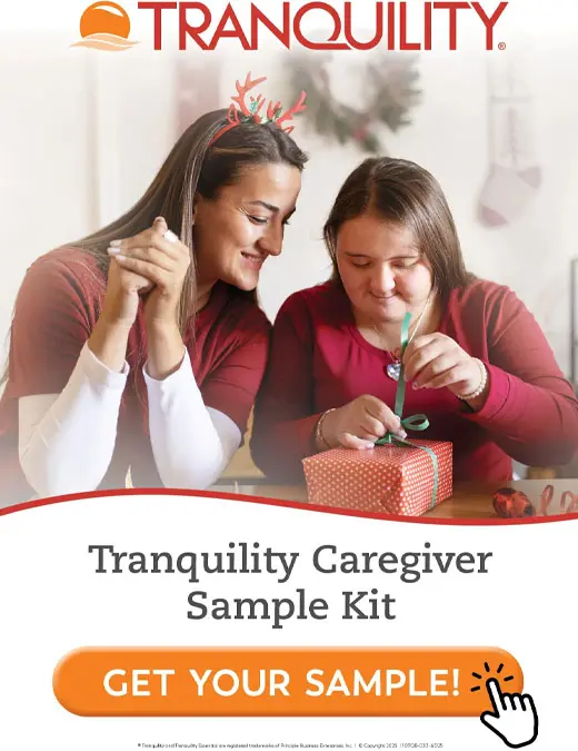 Two women prepare a gift box with a ribbon under a Tranquility logo.