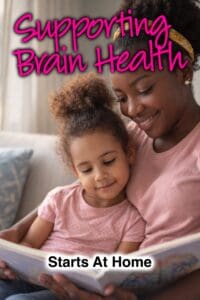 A woman holds a child while reading a book, with the text "Supporting Brain Health Starts At Home" overlayed.
