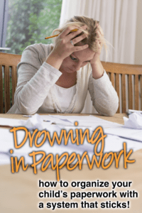 Woman resting her head on a table covered in paperwork, looking overwhelmed.