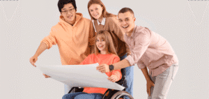 Four students review a blueprint, one in a wheelchair.