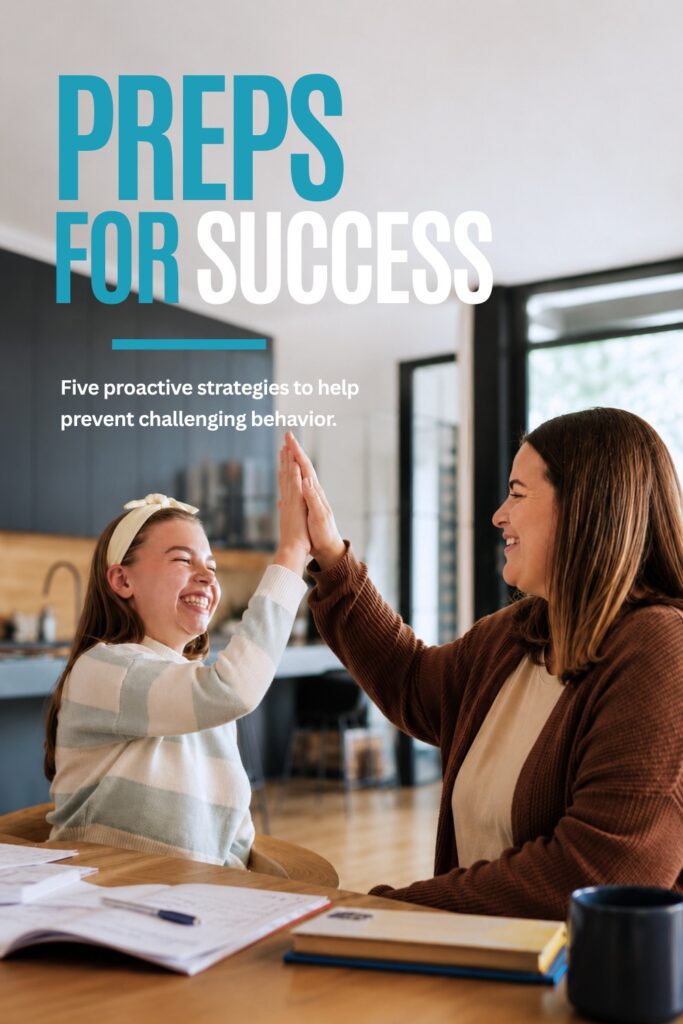 Two people smiling while high-fiving indoors.